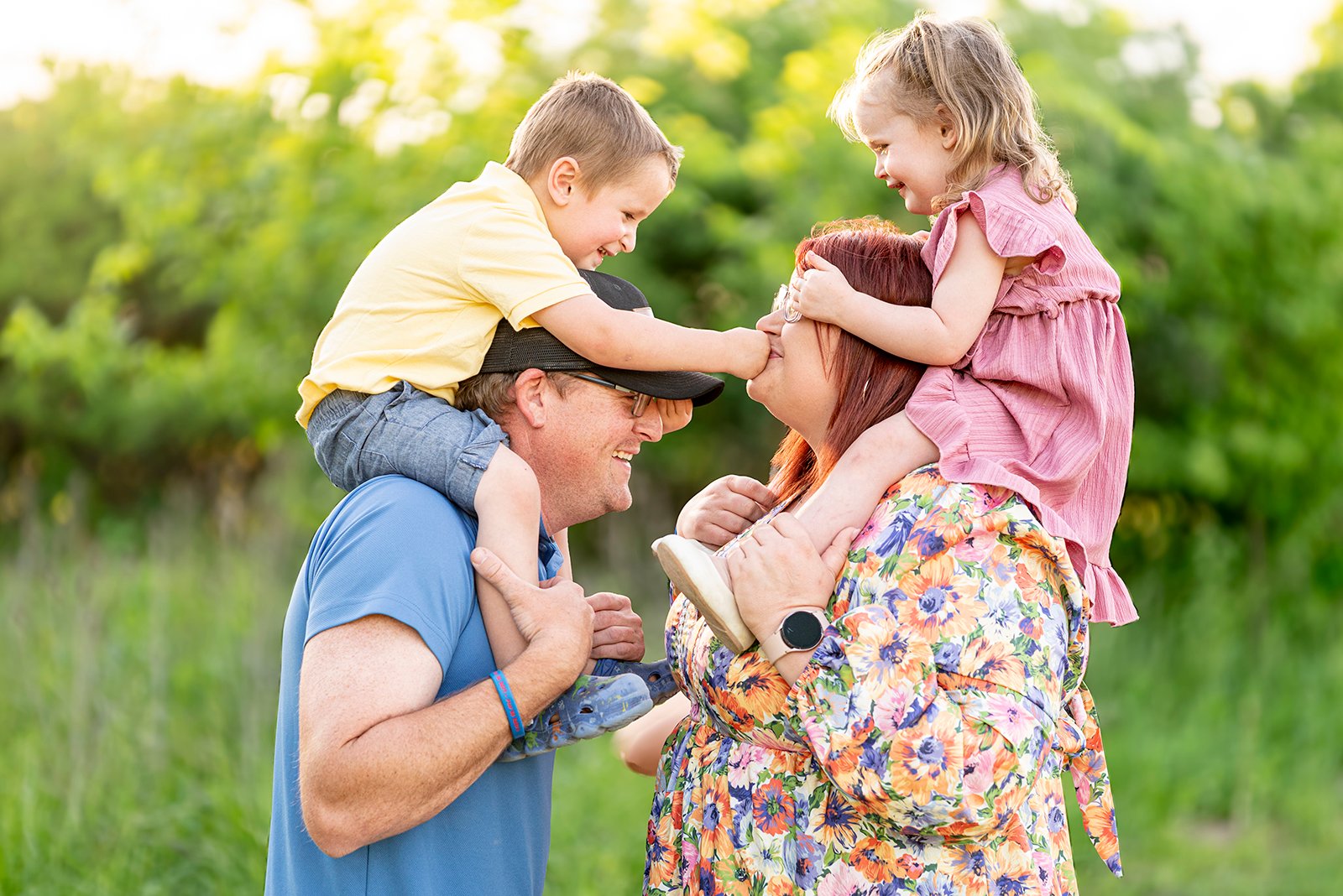 Family image little kids on mom and dads shoulders